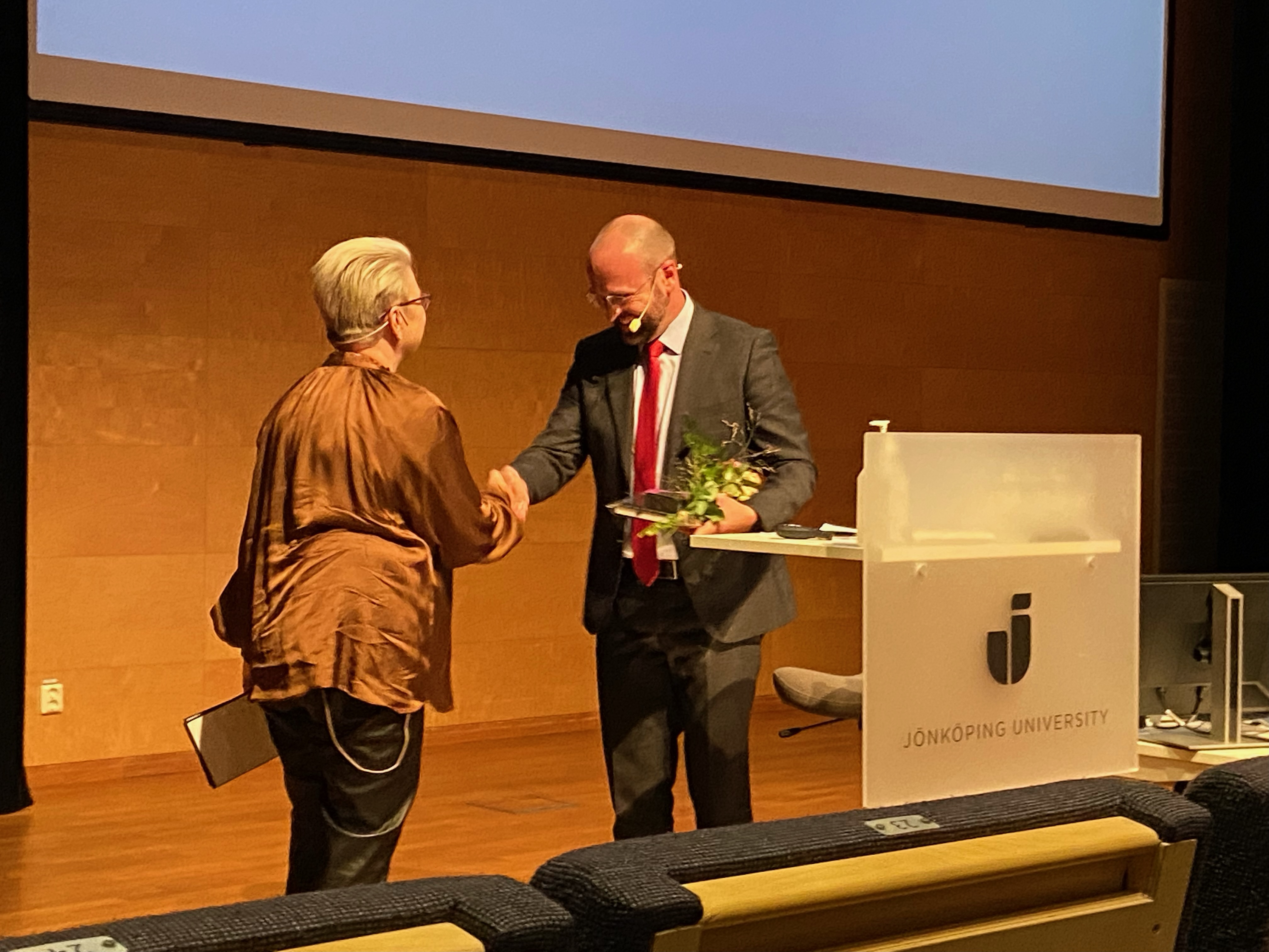 man shaking womans hand